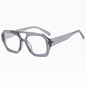 Detailed close-up of geometric transparent grey polygonal sunglasses with double bridge
