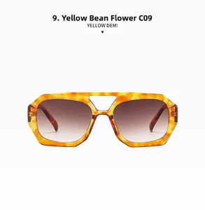 Détail de lunettes de soleil vintage à double pont avec monture ambre jaune et verres dégradés