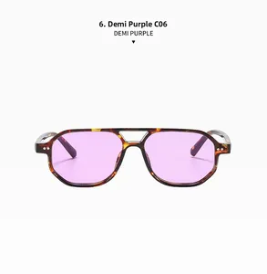 Detail view of demi frames with purple lenses and metallic rivets on retro sunglasses