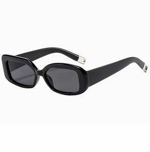 Close-up of sleek black sunglasses featuring thick temples and silver metal cutout details