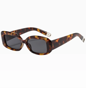 Detailed side view of vintage tortoiseshell sunglasses with thick frames and grey lenses
