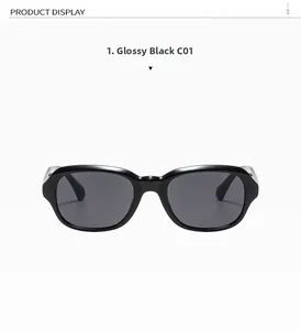 Vue détaillée de la monture ovale noire brillante et des verres UV gris des lunettes rétro