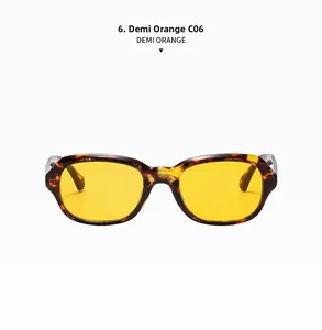 Détail de lunettes de soleil ovales vintage orange demi avec verres jaunes et texture du cadre