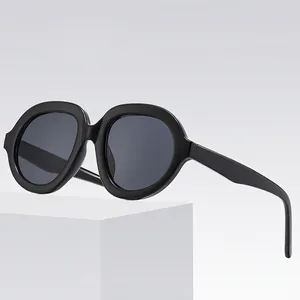 Oversized black round sunglasses with thick frames and dark grey lenses for modern style