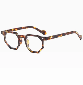 Close-up of irregular tortoiseshell frame glasses with a polished acetate texture