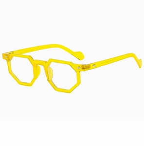 Macro side view of transparent yellow geometric eyeglasses frame with metal rivets