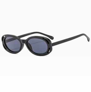 Vue détaillée de lunettes de soleil ovales avec monture ajourée et verres gris foncé