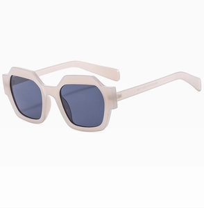 Detailed side view of stylish polygonal cream sunglasses with dark grey UV400 lenses