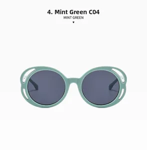 Detail view of mint green round oversized sunglasses with C04 frame and dark gray lenses