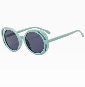 Detail view of round mint green sunglasses with hollow cut-out frames and grey lenses