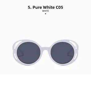 Close-up of white butterfly frame sunglasses with cutout side details and grey lenses