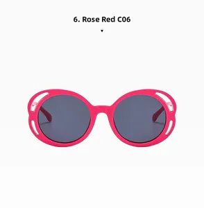 Detail of rose red round sunglasses featuring decorative oval cut-outs on the frame temples