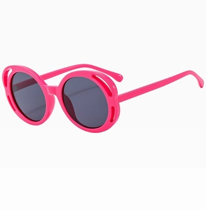 Detail shot of bright pink butterfly frame sunglasses with stylish hollow decorative edges