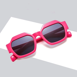 Chic oversized polygon sunglasses in hot pink frame with dark tinted UV lenses