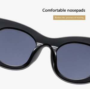 Detail view of thickened integrated nose pads on black cat-eye sunglasses frames