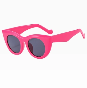 Side view of trendy bright pink cat-eye sunglasses with thick frames and dark lenses