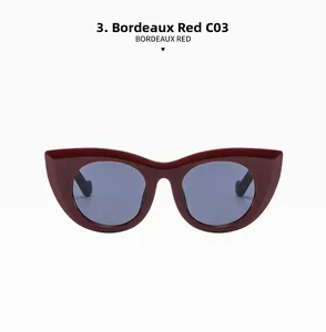 Close-up of Bordeaux Red cat-eye sunglasses featuring glossy thick frames and grey lenses