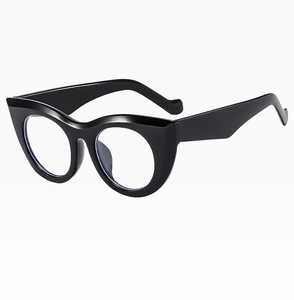 Detail view of bold black cat-eye thick frames with clear lenses from a side angle