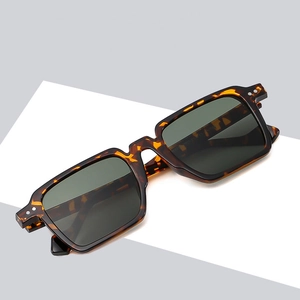 Square tortoiseshell sunglasses with dark lenses and metallic rivets on light grey background