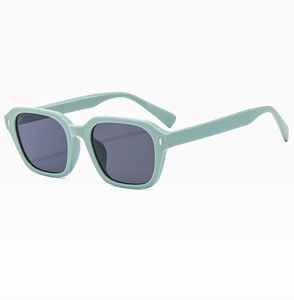 Detail shot of vintage square mint green sunglasses with silver rivets and grey lenses