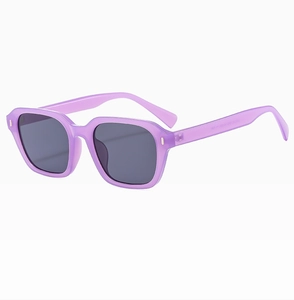 Detail view of purple square sunglasses with silver rivets and dark grey lenses