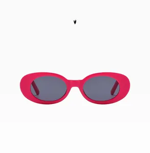 Detail of trendy rose red oval sunglasses featuring high-quality UV protection lenses