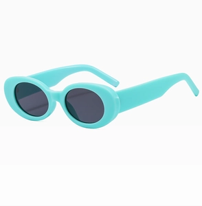 Detail shot of vintage oval sunglasses with a glossy light blue resin frame and dark lenses