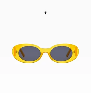 Detail of light yellow oval sunglasses with C05 model mark and dark lenses