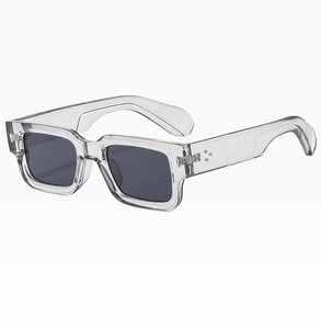 Detail view of transparent square sunglasses featuring classic triple metal rivet accents