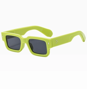 Detail of neon green square sunglasses with metal rivets and dark grey tinted lenses