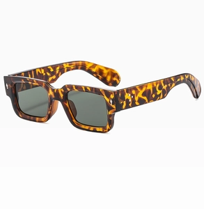 Detail showing retro tortoiseshell pattern thick frames and silver rivets on square sunglasses