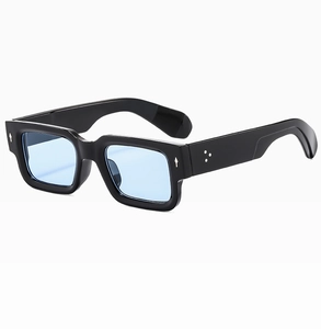 Detail of vintage square sunglasses with silver arrow rivets and light blue lenses