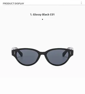 Detail of glossy black cat-eye sunglasses featuring silver metal studs and gray lenses