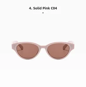Detail of pink cat eye sunglasses with metal rivet accents and brown lenses