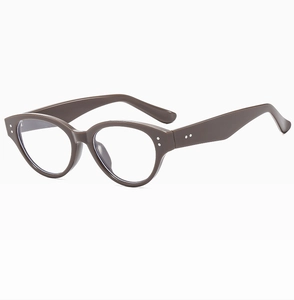 Detailed side view of vintage brown cat-eye glasses frame with silver rivet accents