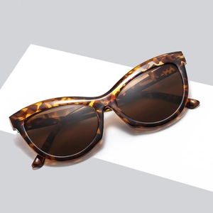 Retro cat-eye sunglasses with tortoiseshell frame and brown lenses at a 45-degree angle