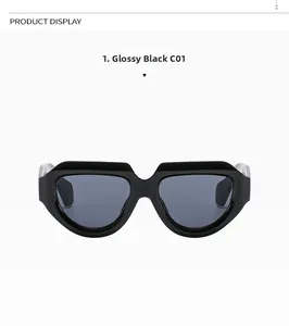Detail view of bold irregular black sunglasses with thick frames and dark lenses
