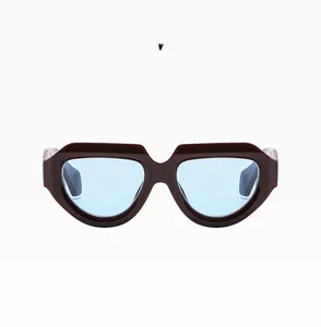 Detail of bordeaux wide frame sunglasses with light blue lenses and industrial design