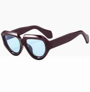 Macro side view of oversized geometric sunglasses with thick burgundy frames and blue lenses