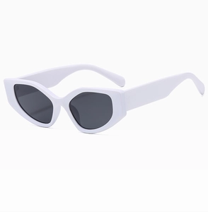 Close-up of modern cat-eye sunglasses with thick white frames and dark grey lenses