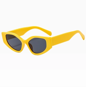 Detail view of bold yellow cat-eye sunglasses with thick temples and dark lenses