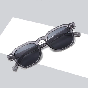 Vintage oval translucent grey sunglasses with dark lenses and metal rivets