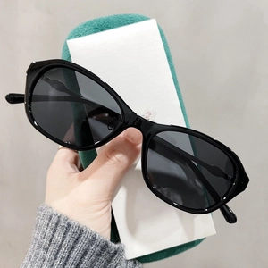 Nahaufnahme der schwarzen Cateye-Sonnenbrille mit gewellten Bügeln und Metalldetails