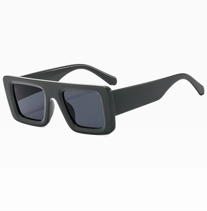 Detail of vintage rectangular black sunglasses with thick frames on a white backdrop