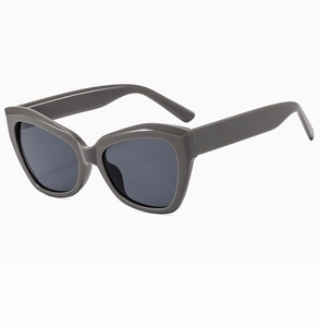 Detailed side view of retro cat eye sunglasses featuring thick dark grey acetate frames