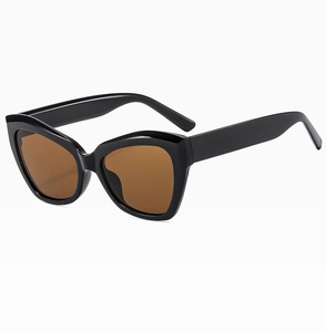 Detail of vintage cat-eye sunglasses with sleek black frame and brown tinted lenses