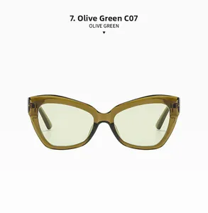 Close-up of retro olive green cat eye sunglasses with transparent frames and green lenses