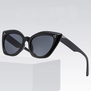 Black cat-eye sunglasses with thick glossy frames and triple silver rivet details