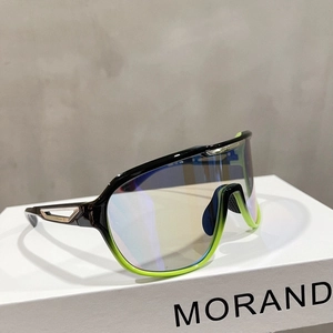 Detail of oversized sports sunglasses with black and green frame and blue mirror lens