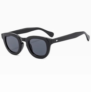 Close-up of stylish black frame sunglasses with dark lenses and silver metal hinges